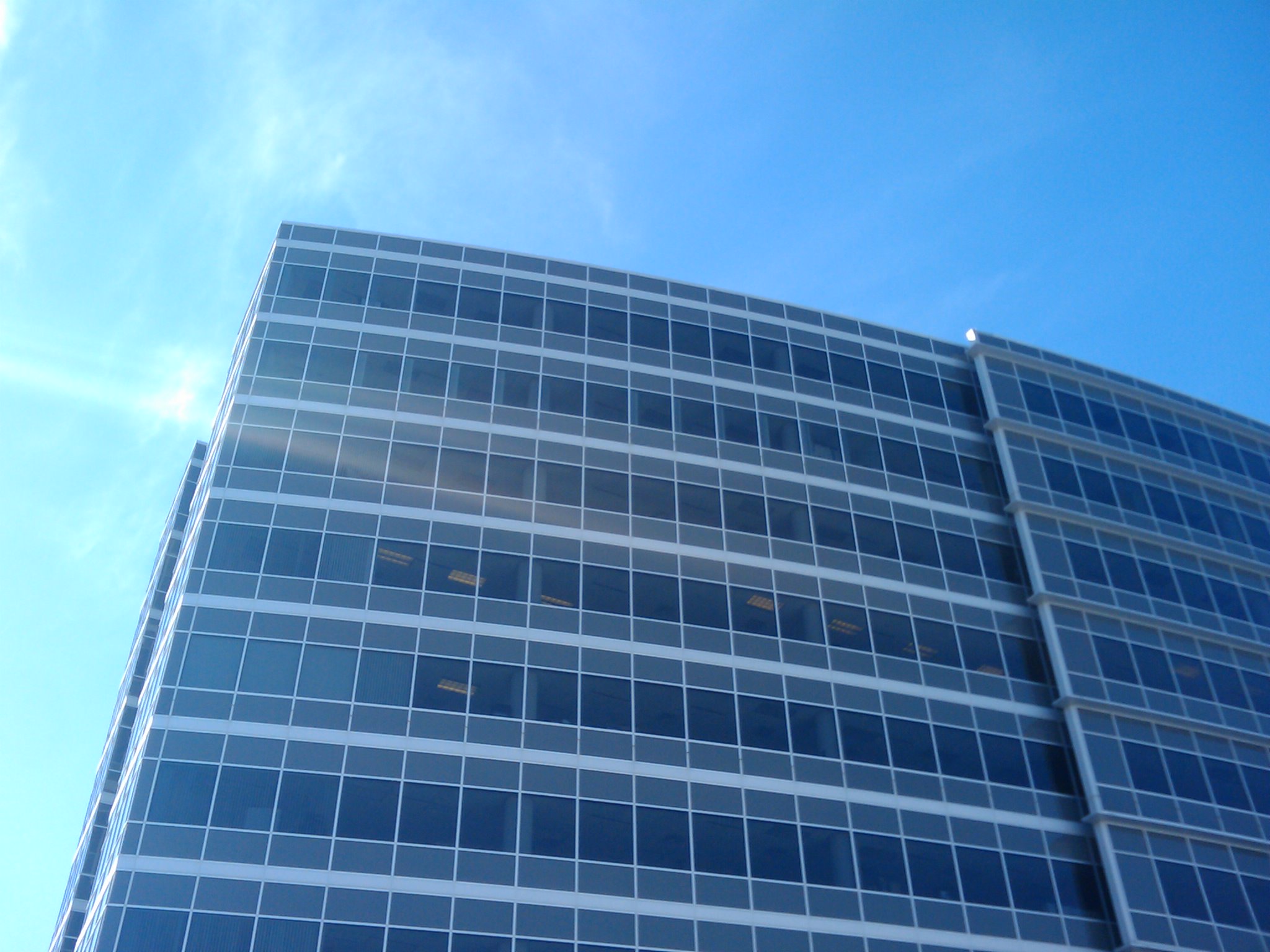 the front side of an office building has many windows