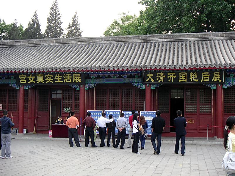 a group of people standing in front of an old building