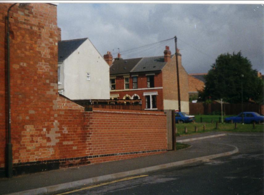 two houses that are next to each other on a brick wall