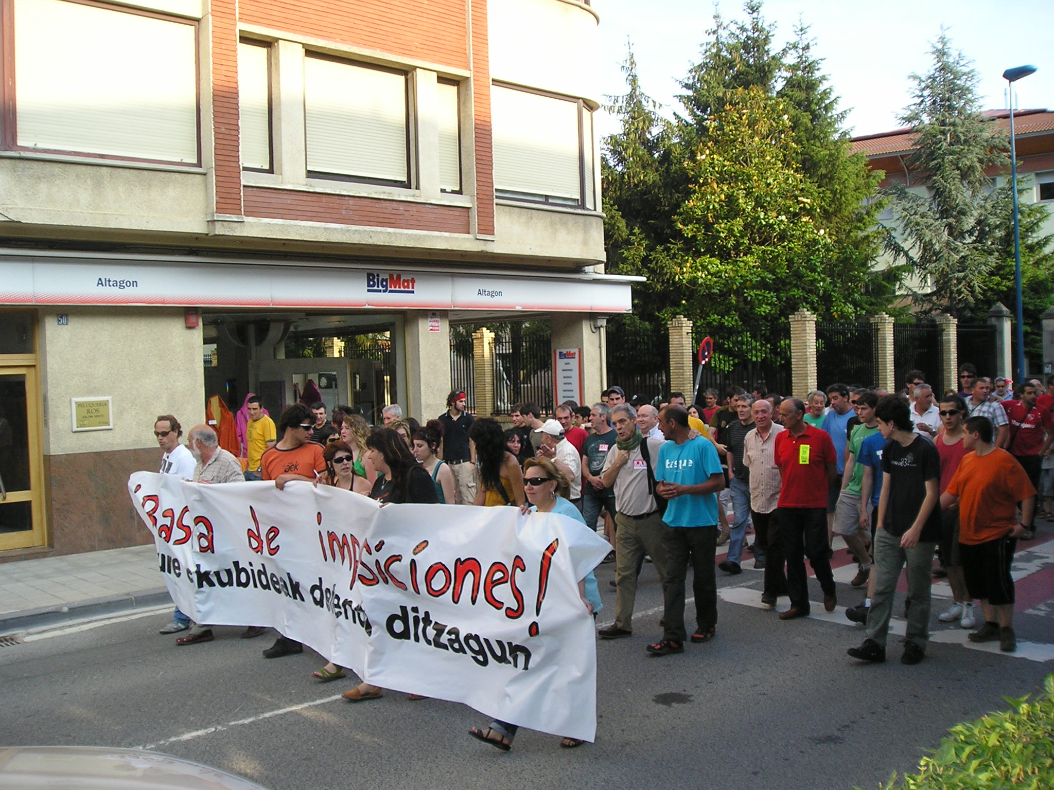 a group of people walking with a large sign