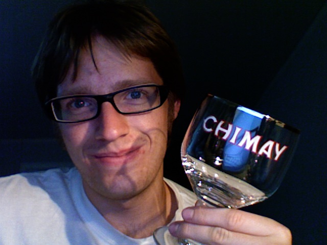 a person holding a wine glass with a red label on it