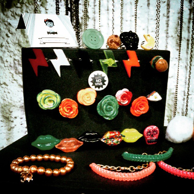 a bunch of small colorful necklaces sitting next to each other