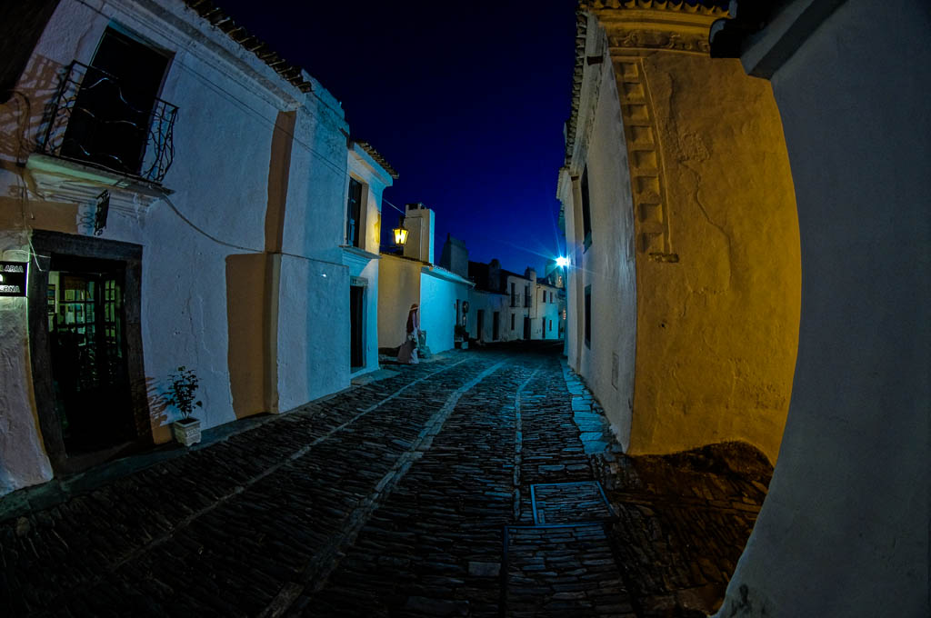 a narrow street in an old city at night