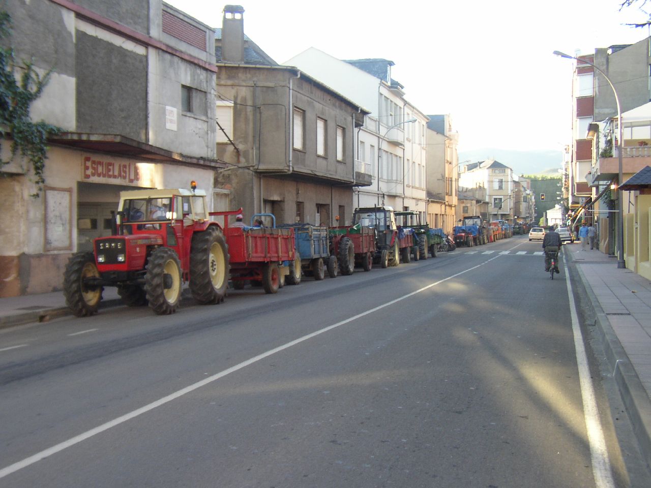 a tractor carrying several parts is being transported down the street