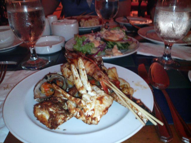 a plate of meat with chopsticks on a table