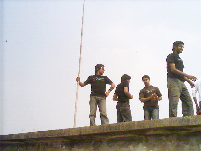a group of men hanging out together on a bridge