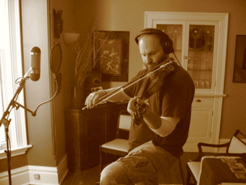 a man holding an instrument in a living room