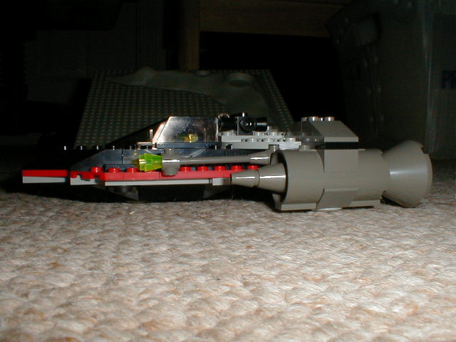 a lego star wars ship is placed in front of a lego model