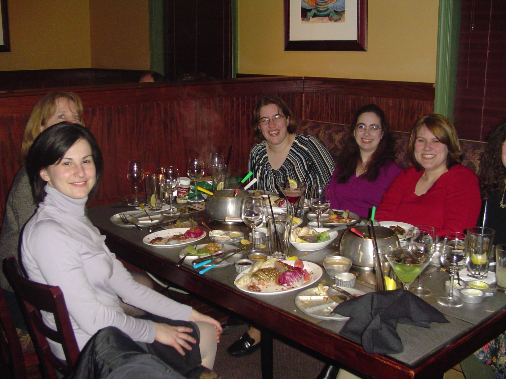 seven women sit at the dinner table for a meal