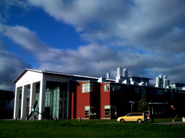 a yellow car parked in front of a building