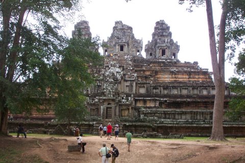 tourists walk through the ruins of angah temples
