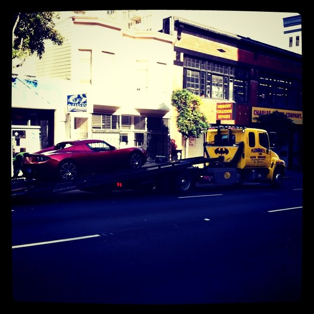 a tow truck and a car on the road