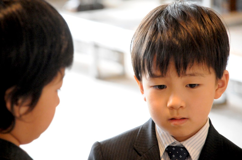 the little boy is dressed in business attire