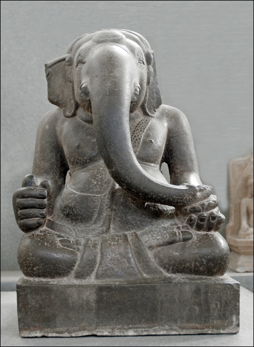 an old and worn statue of an elephant with tusks