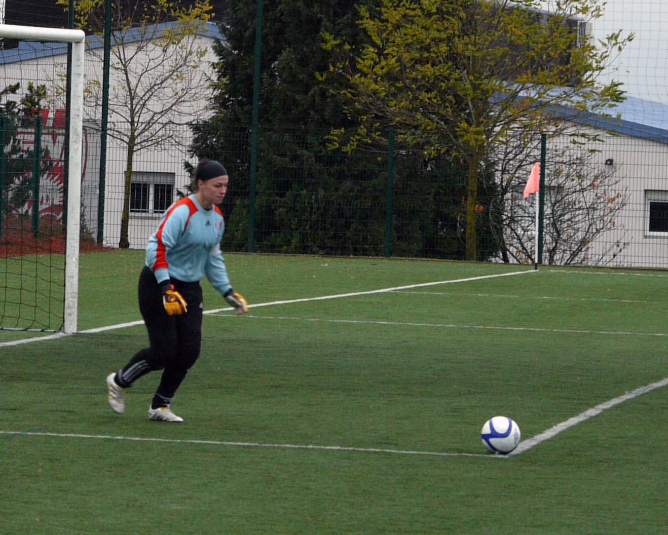 a woman playing soccer on the field with a ball