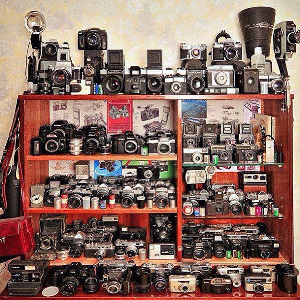 large number of different cameras on a shelf