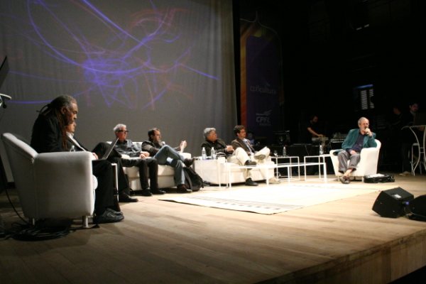 people sitting on chairs at an event on a stage