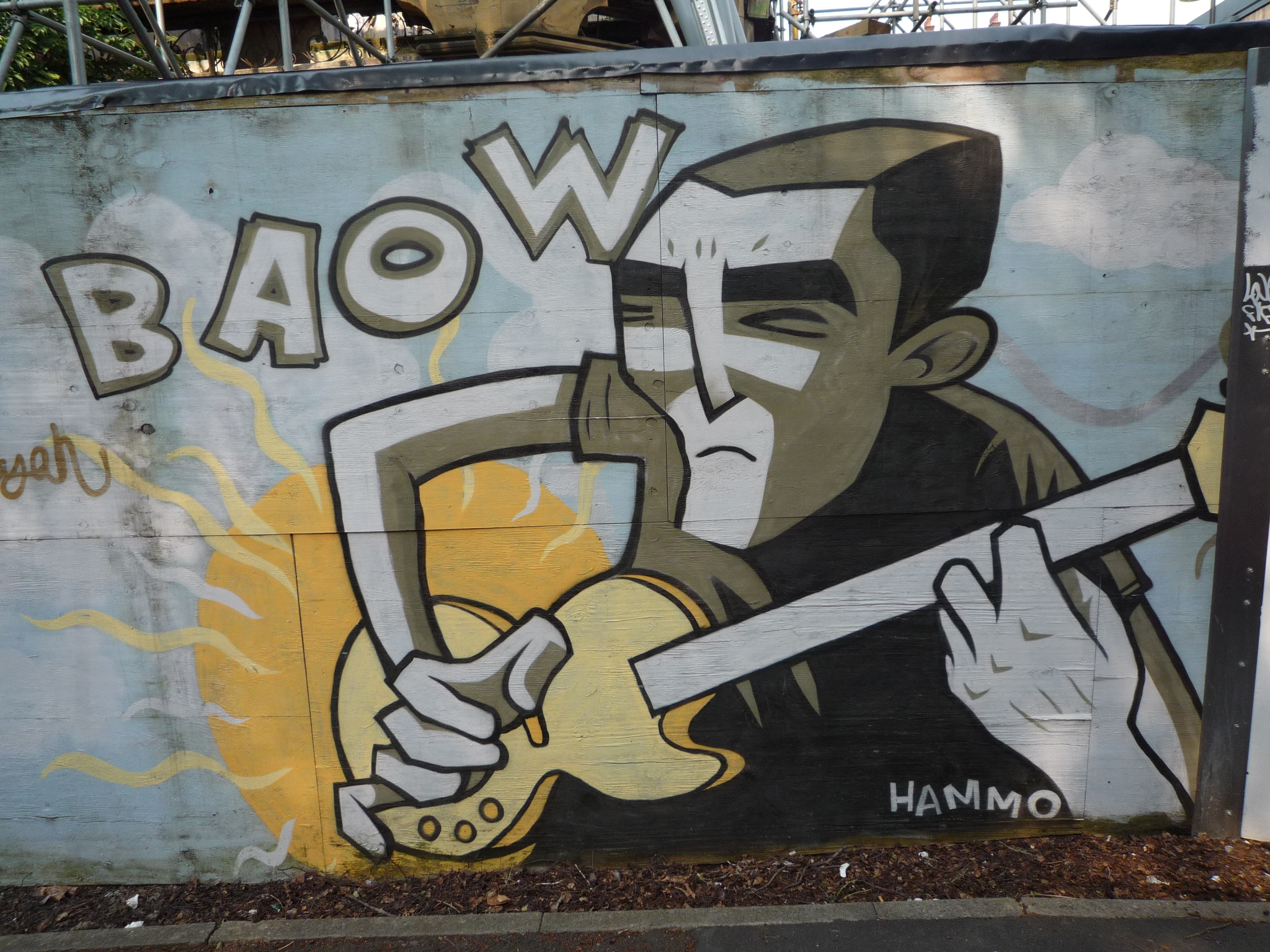 a large graffiti piece of a man holding a hammer with a hand and fire