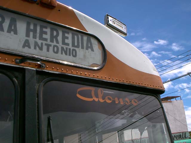 a closeup of the side of an orange and white bus