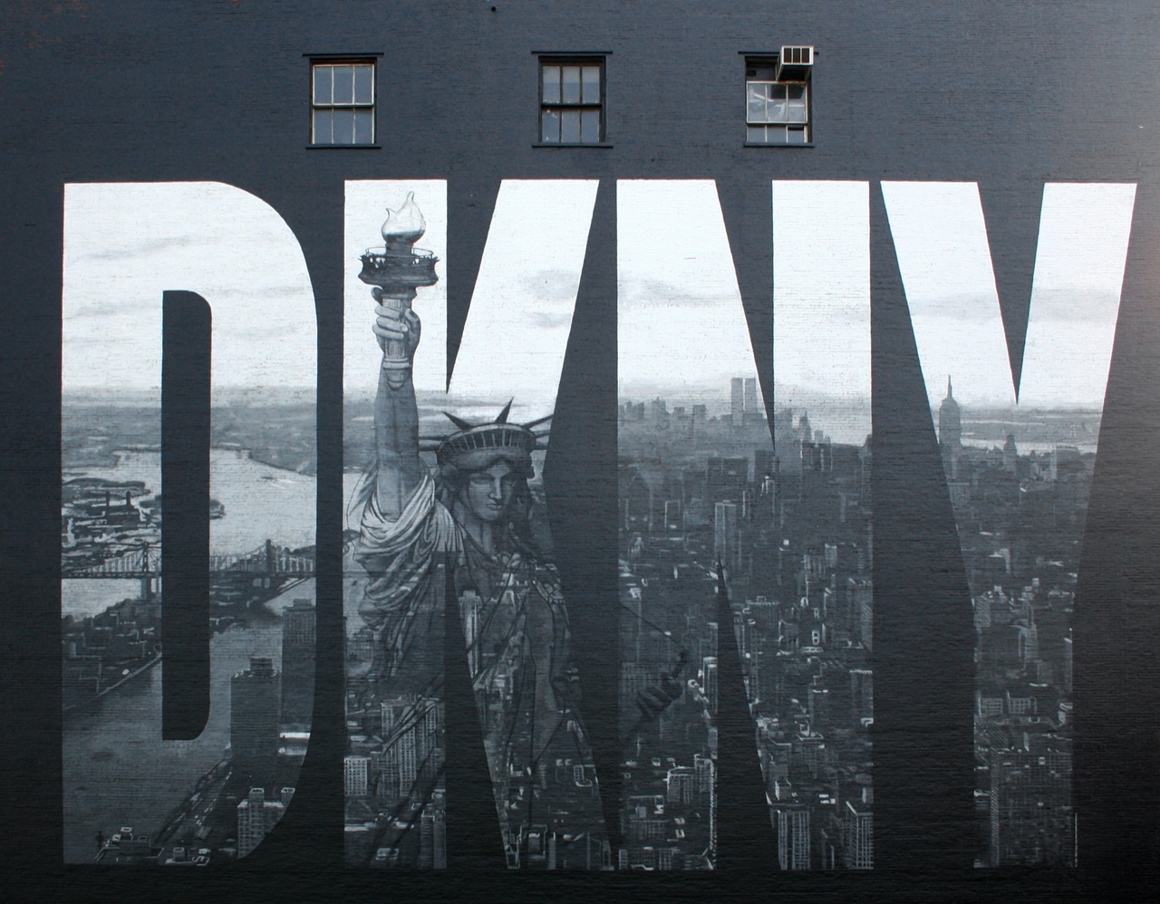the words dwb on the side of a building with statue of liberty