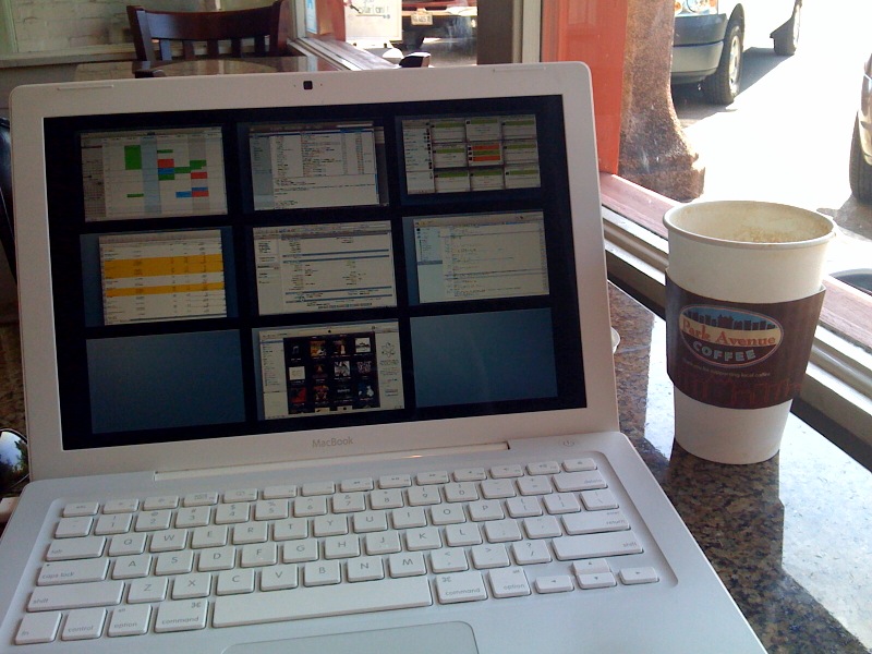 an open laptop computer sitting next to a cup of coffee