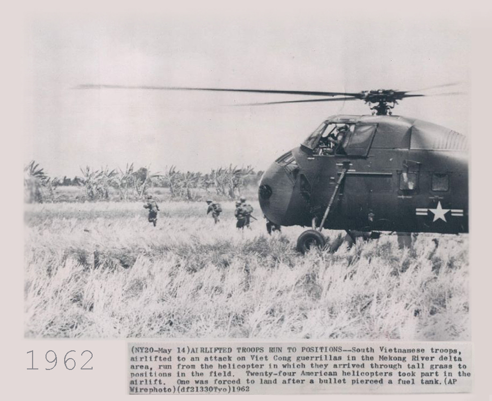 this black and white po shows some men preparing a helicopter