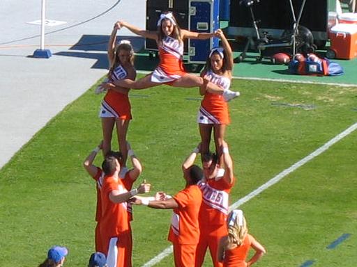 a group of cheerleaders dancing on the field