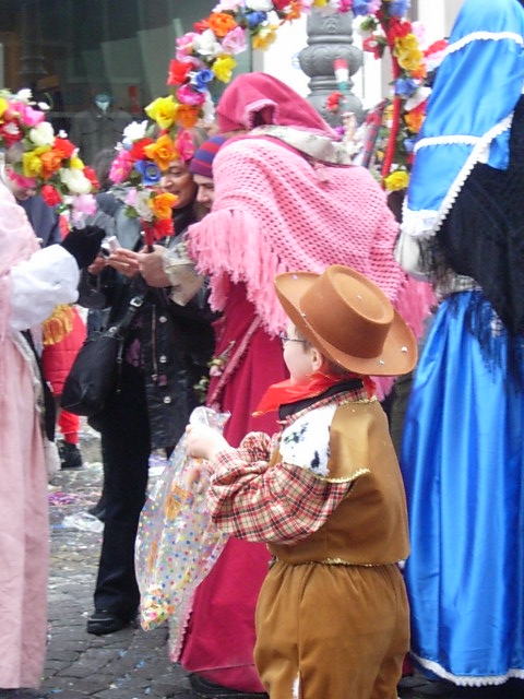 a  standing next to a child dressed in costumes