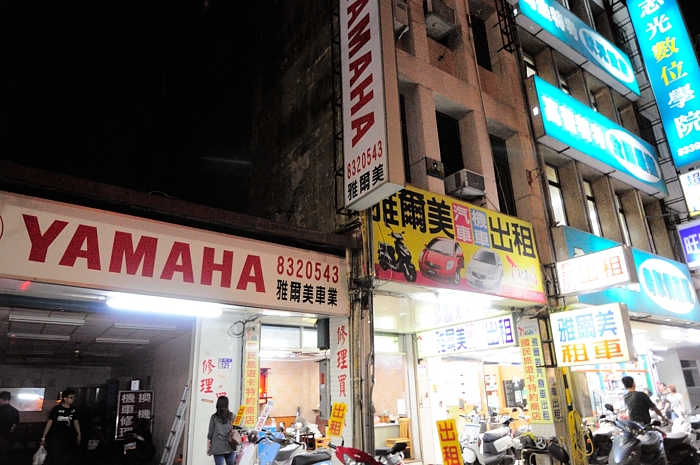 an asian restaurant in front of a building at night