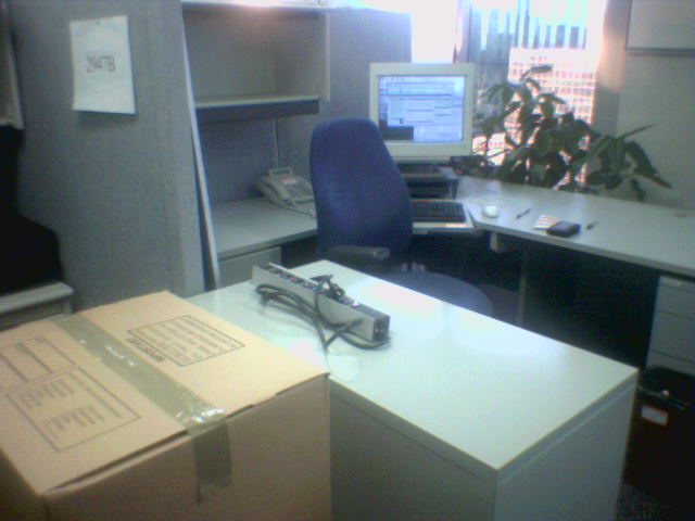 an open filing box sitting on a cubicle desk in an office