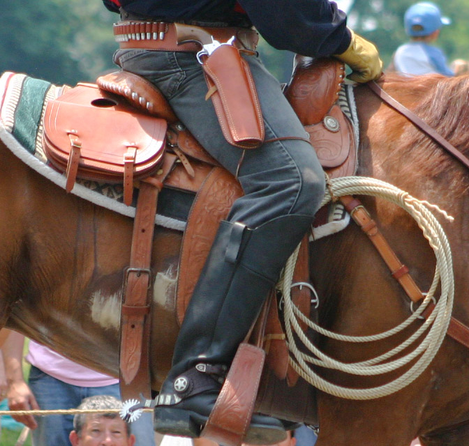 a cowboy rides a horse at a rodeo
