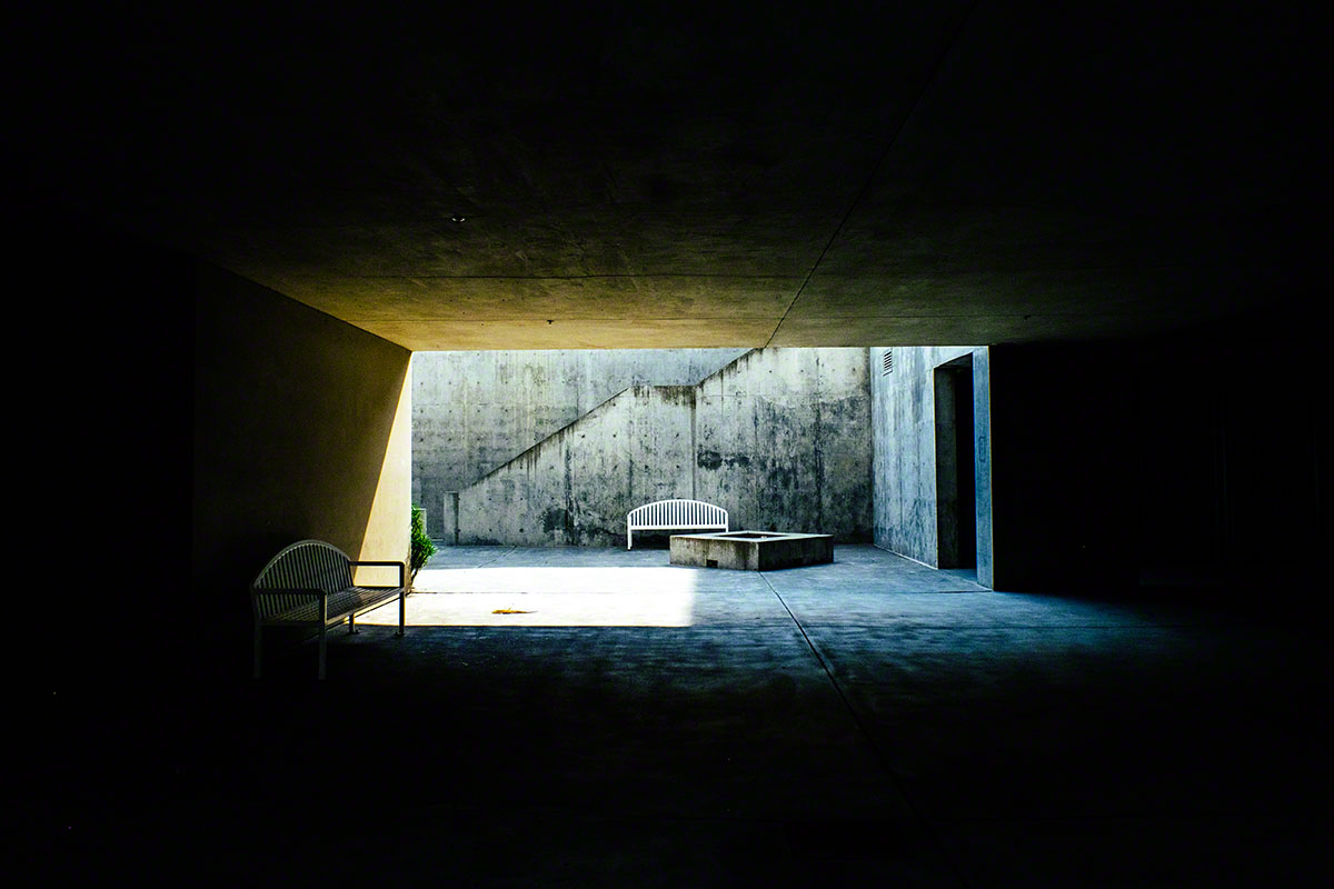 an empty room that has a chair and table