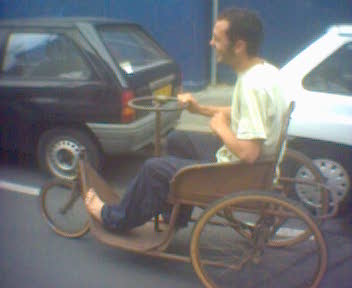 a man in a wheel chair sits on the street