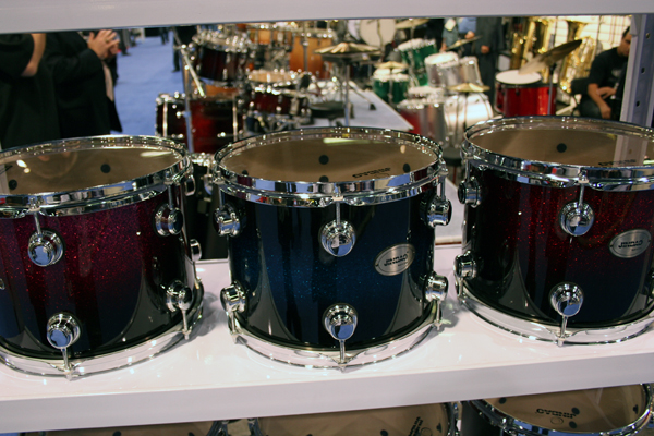 a row of drum sets lined up against each other