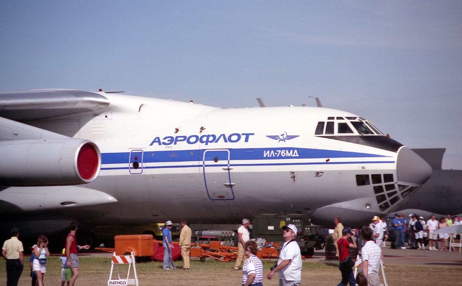 people are walking towards the large airplane at an airport