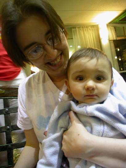 an image of woman smiling holding a baby