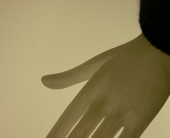 a white hand with a long thin black hair