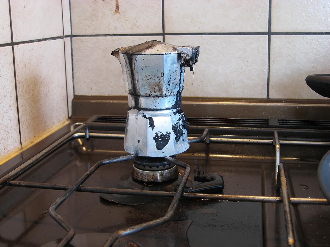 a stove burner sitting inside of a kitchen next to tiled wall