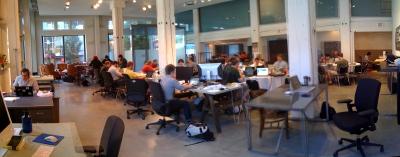 a room full of people working with computers