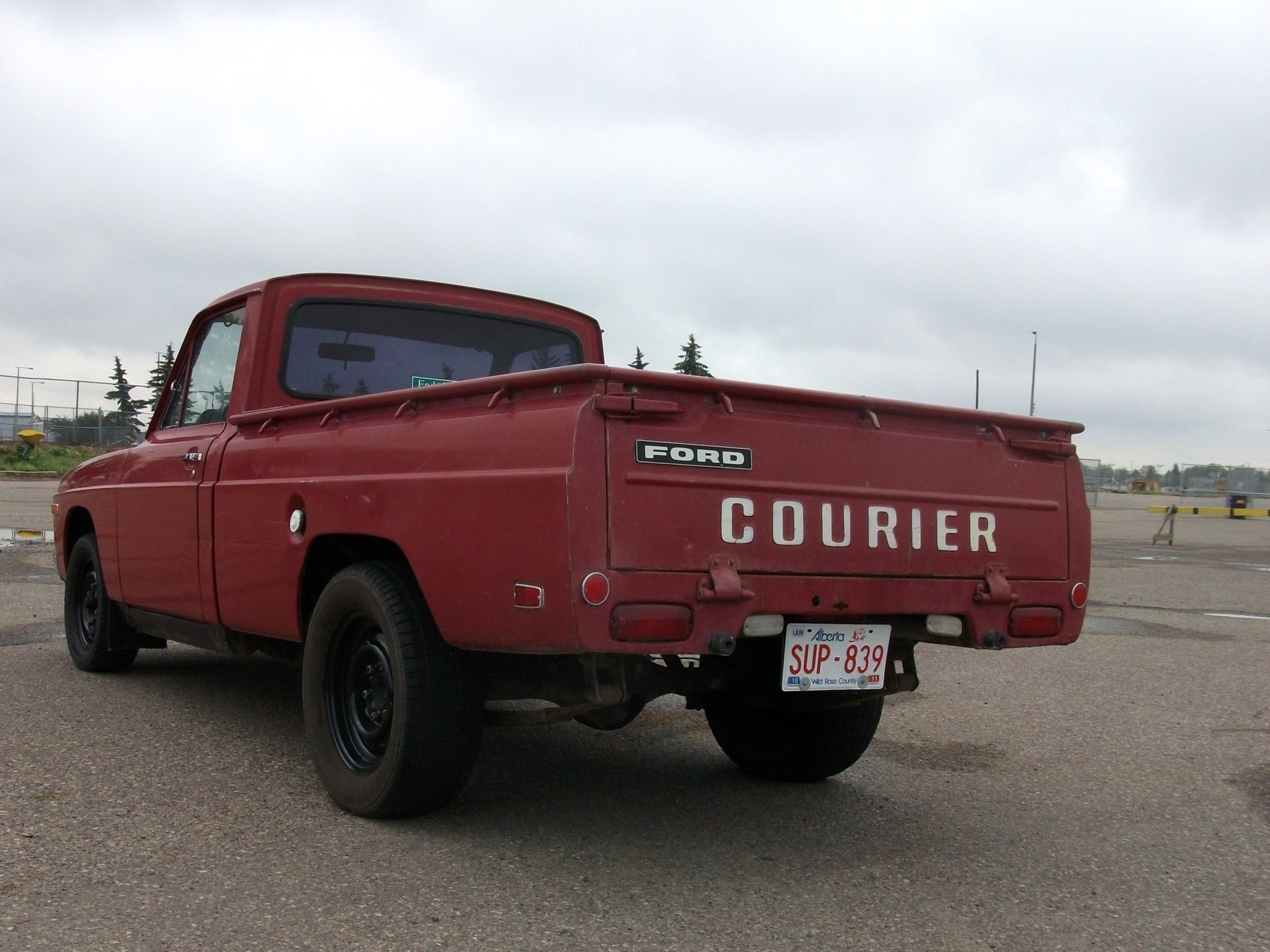 a ford truck is parked on a street