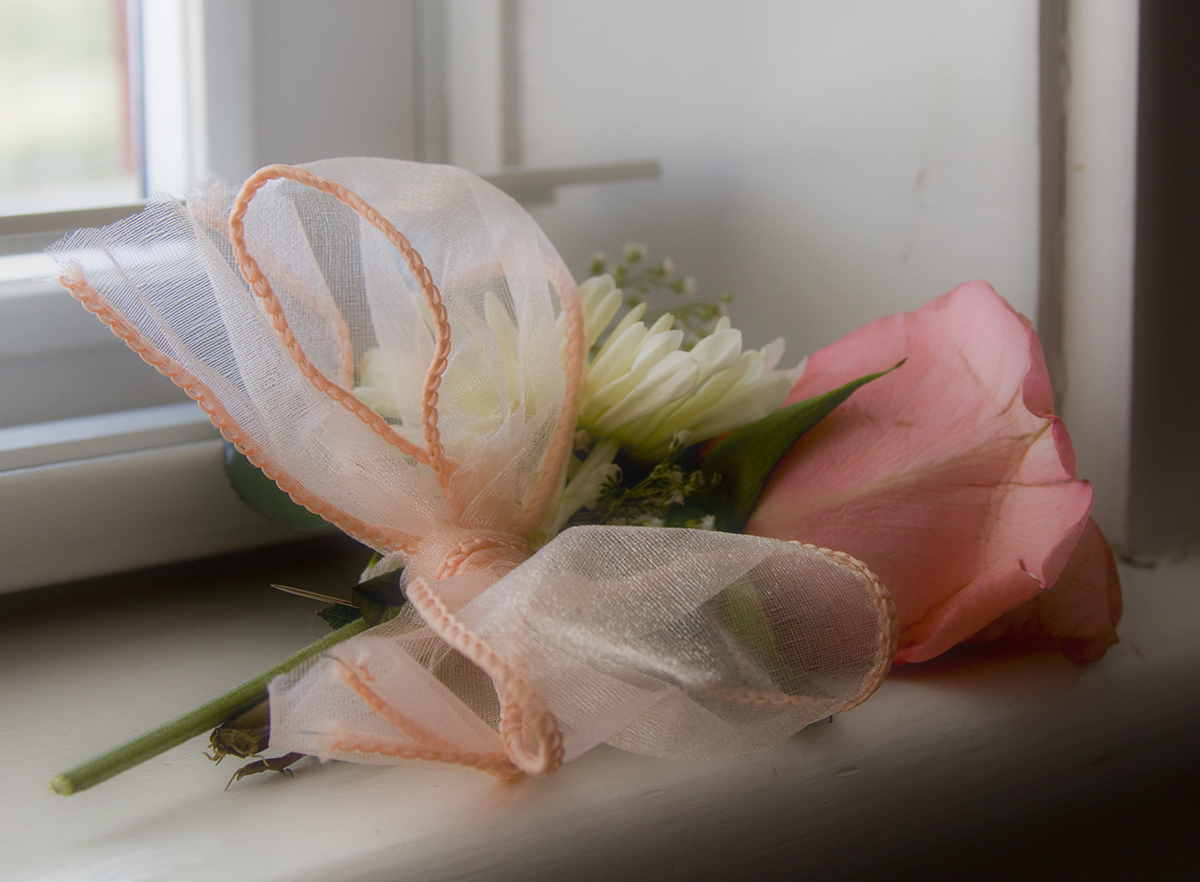 pink flowers and white and pink tulle flowers on window sill