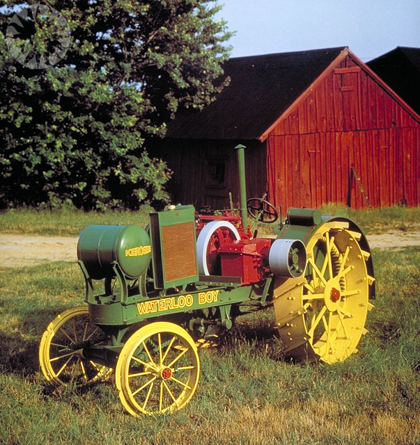 a vintage green tractor with two yellow tires