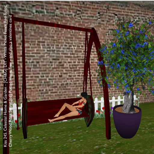 a garden with blue flowers, trees and swings