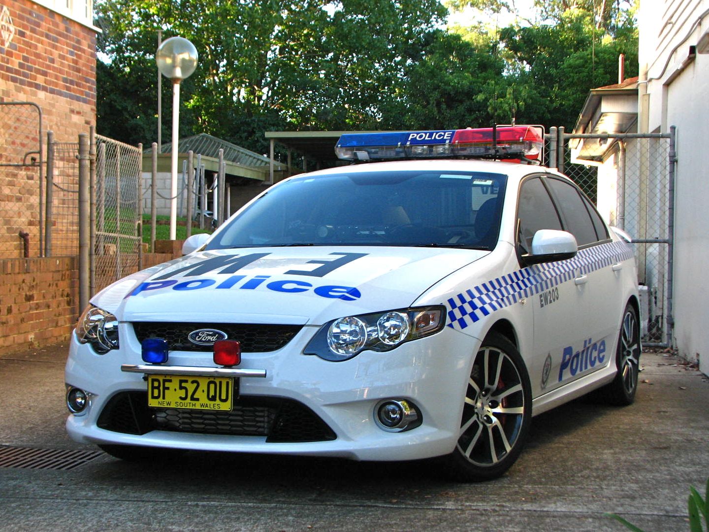 a white police car parked in front of a building