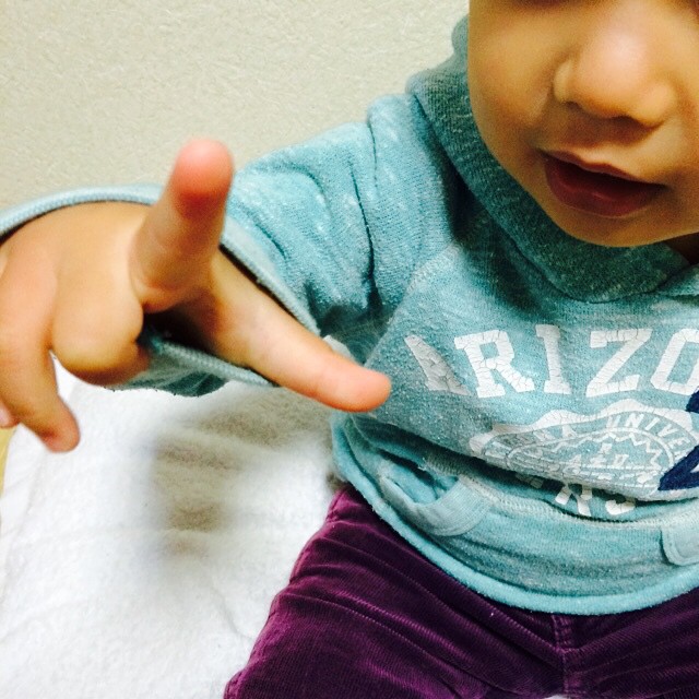 a small child making a gesture with his fingers