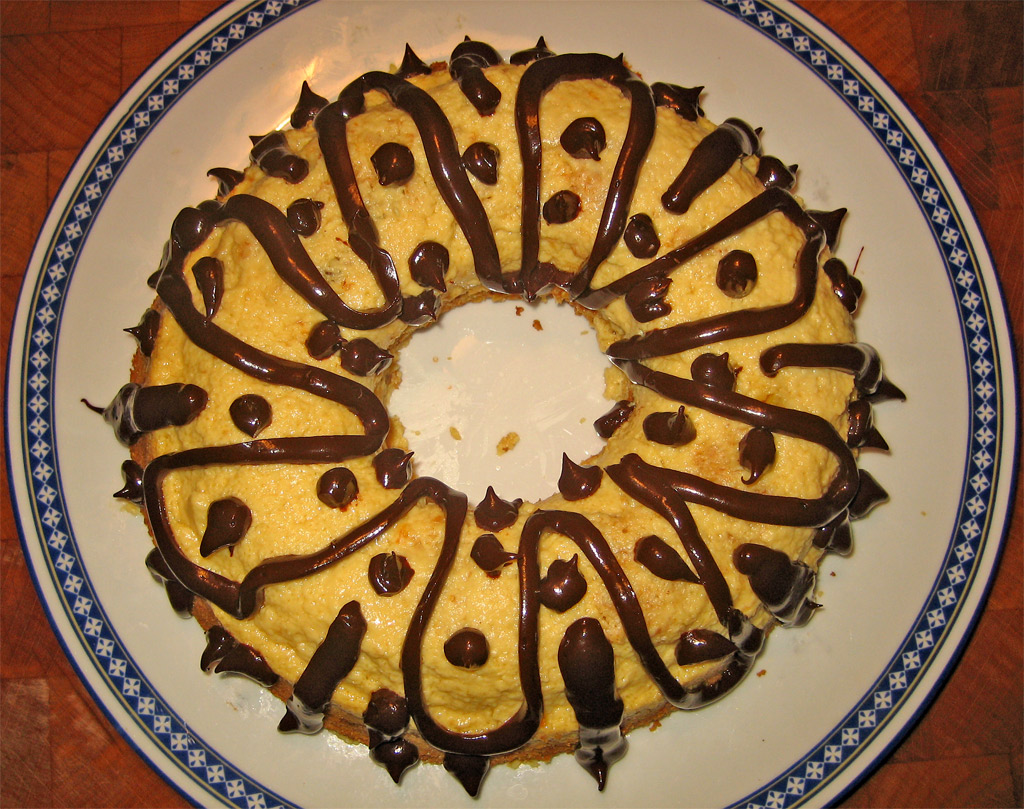 a cake on a plate with some chocolate drizzled on top