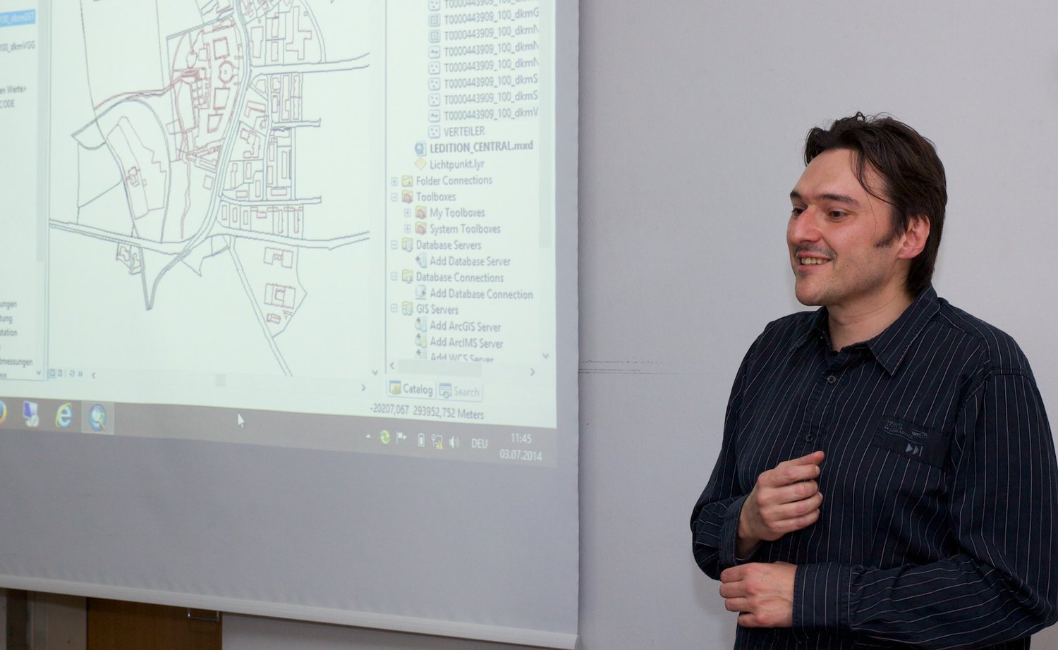 a man talking to a group of people about his project