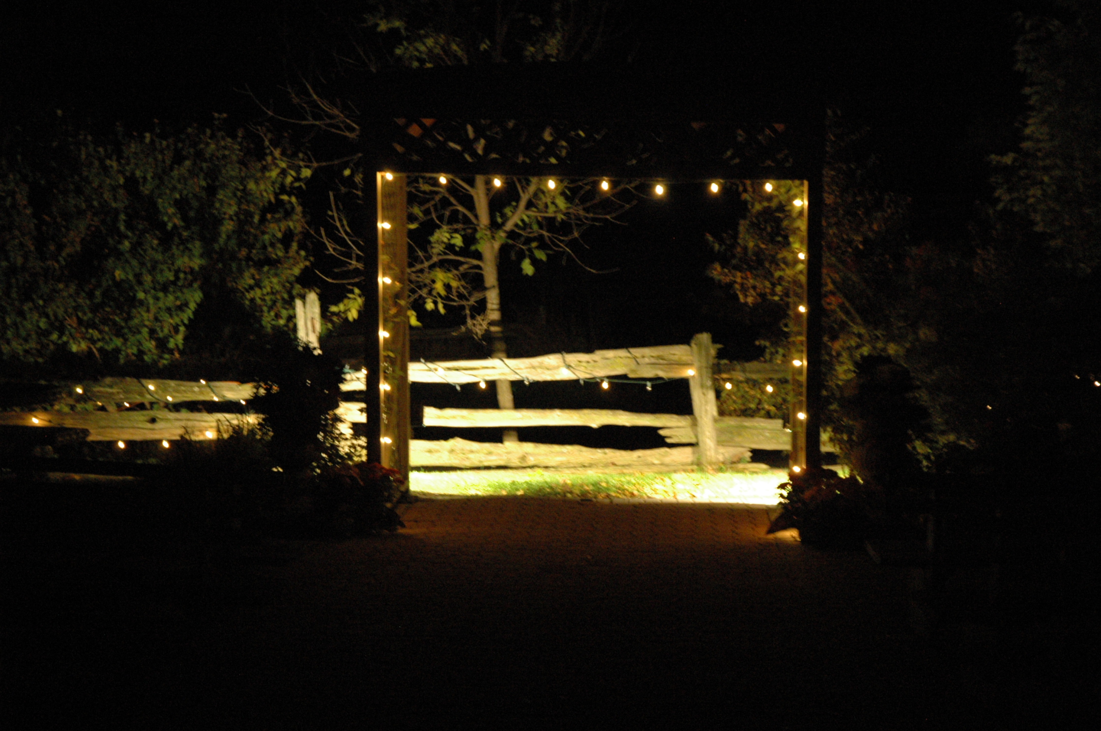 a wooden fence with lights attached to it