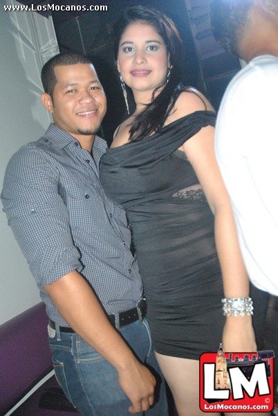 a man standing next to a woman at a club