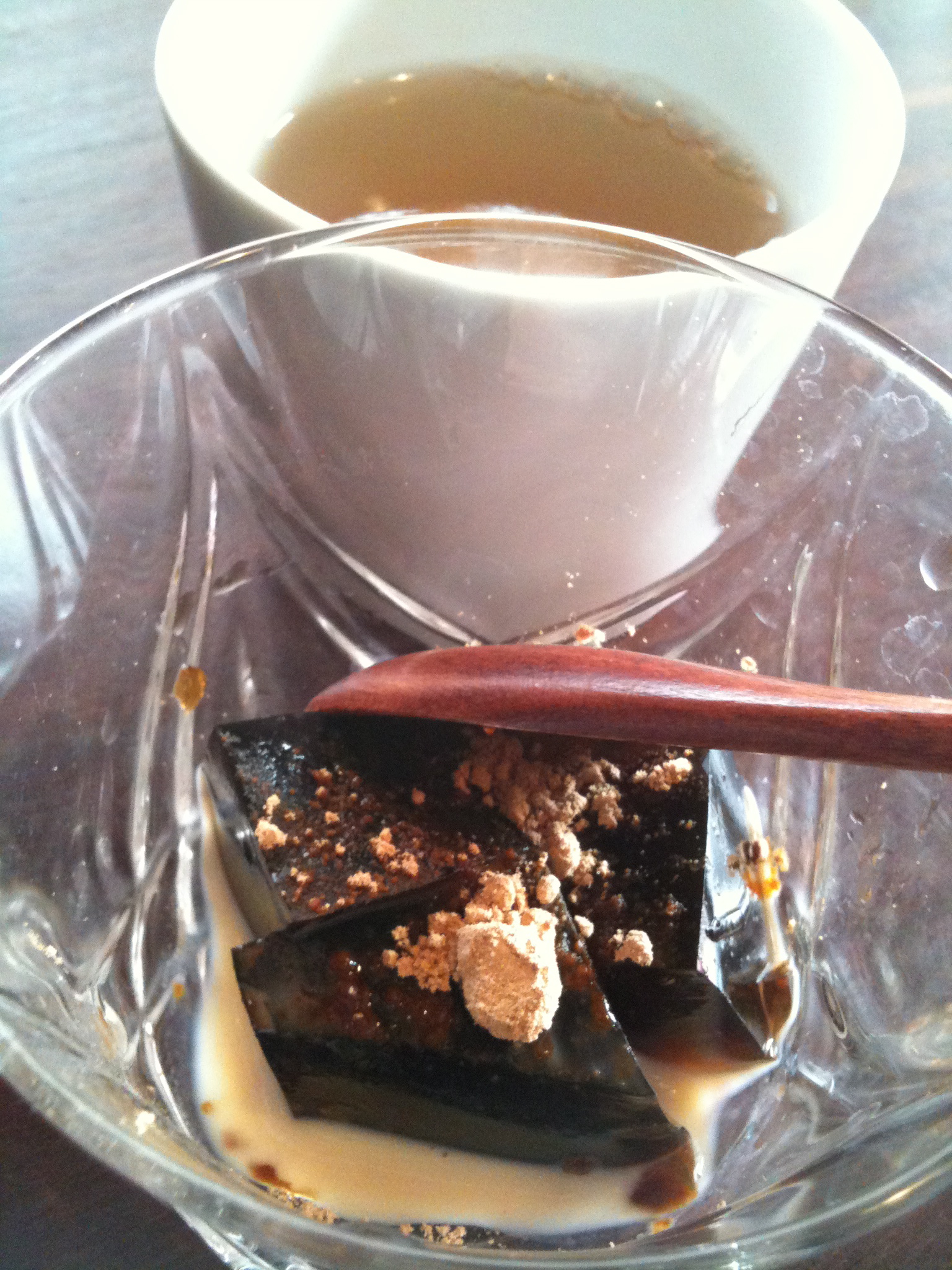 a plate of food on the table beside a cup of tea